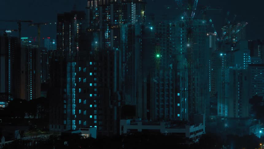 A group of tall cranes facilitate the construction of a large skyscraper