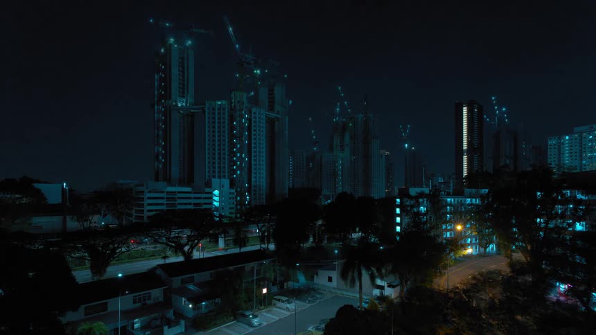 A city skyline with buildings and construction cranes with the sky in the background