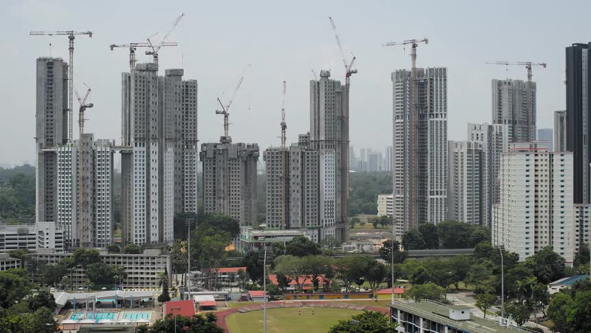 A group of tall buildings growing quickly with clouds in the background