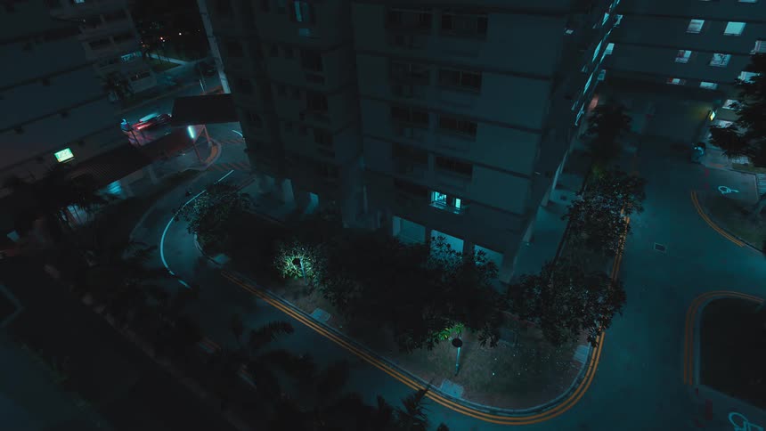 A time lapse shows some automobiles driving along city streets at night