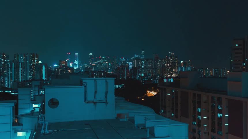 A busy road running an illuminated metropolis at night