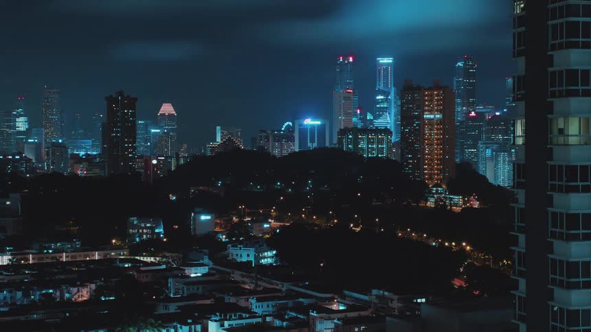 A city skyline with buildings with the sky and clouds in the background
