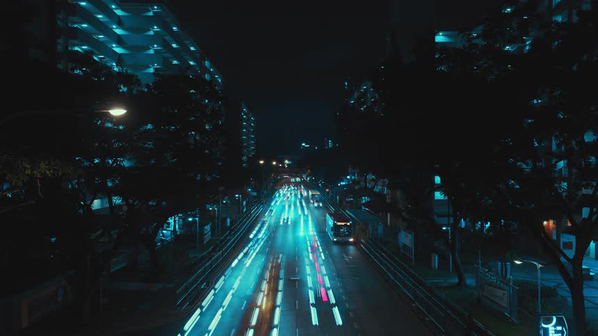 A view of cars driving down a road in a time lapse