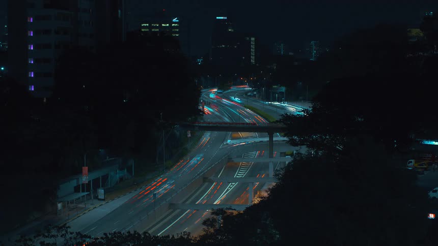 Cars are driving down the street at fast speeds