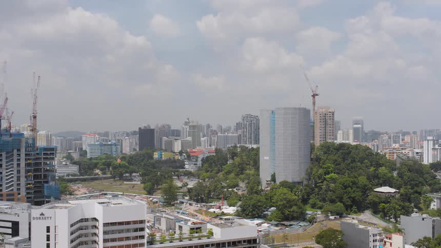 Construction crews use cranes to build a tall structure downtown