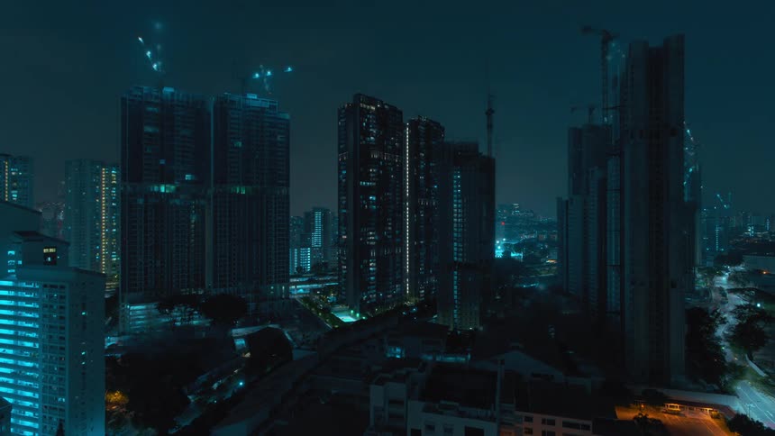 A time lapse reveals multiple cranes atop skyscrapers at night