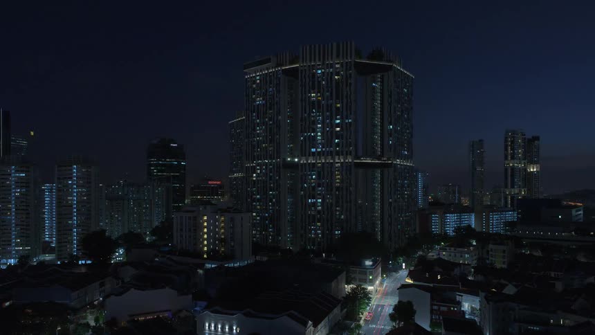 A city with buildings and trees with the sky and clouds in the background