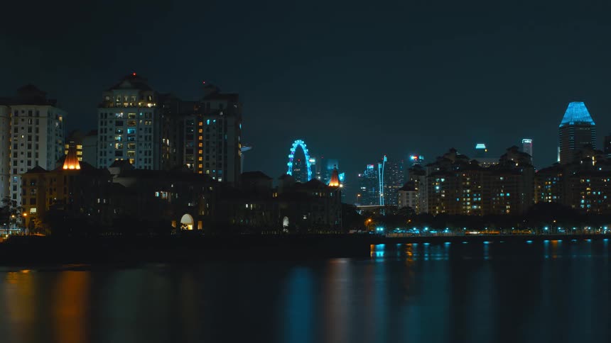 Time lapse of cars driving on the shore and the singapore city skyline