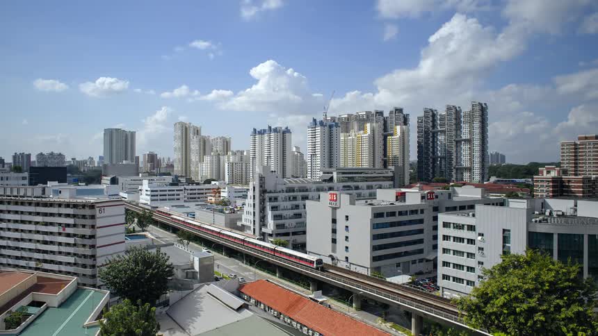 Time lapse of trains driving through the buildings on the city downtown at daytime