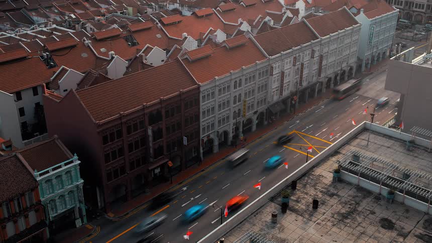 A city with streets buildings vehicles and pedestrians changing from day to night