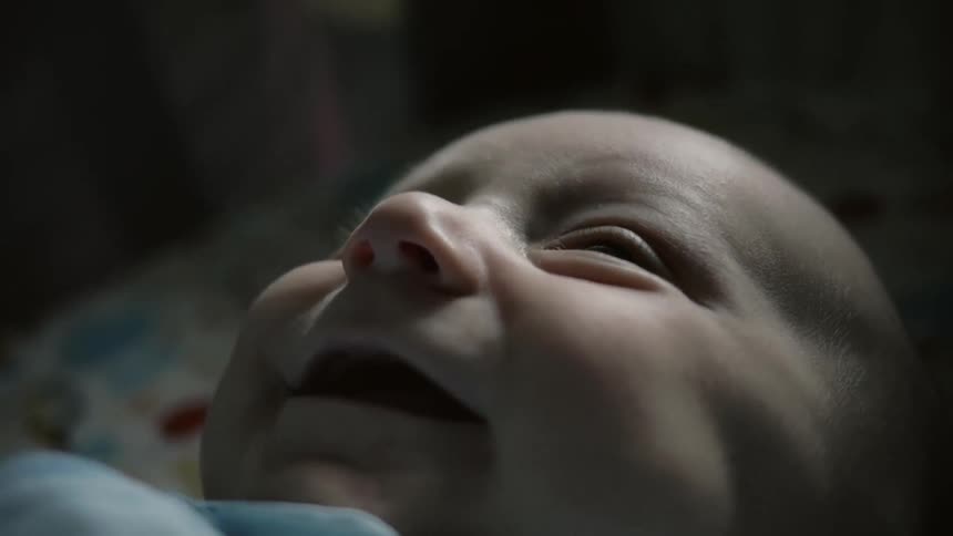 Happy infant lying on their back