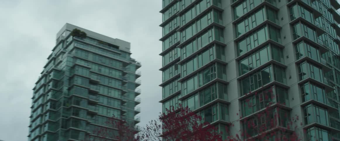 Glass facade of the tall skyscrapers on the city downtown at daytime