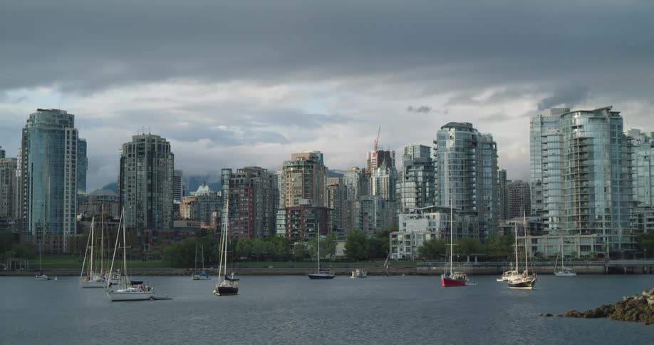 Boats sailing on the water in front of the city skyline