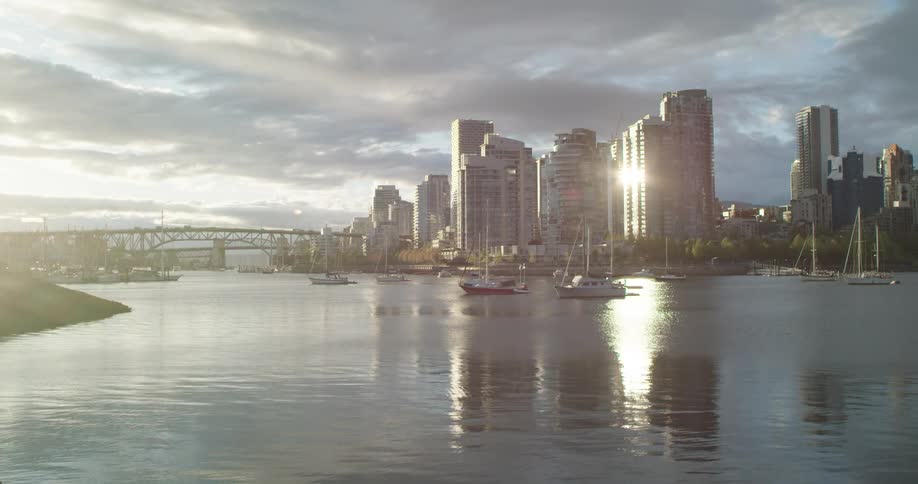 Wide view of the water with boats and some high rise buildings visible in the background