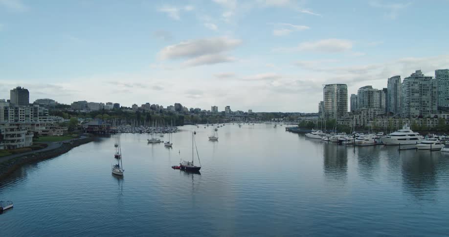 Vancouver's False Creek with boats and buildings with the sky and clouds in the background