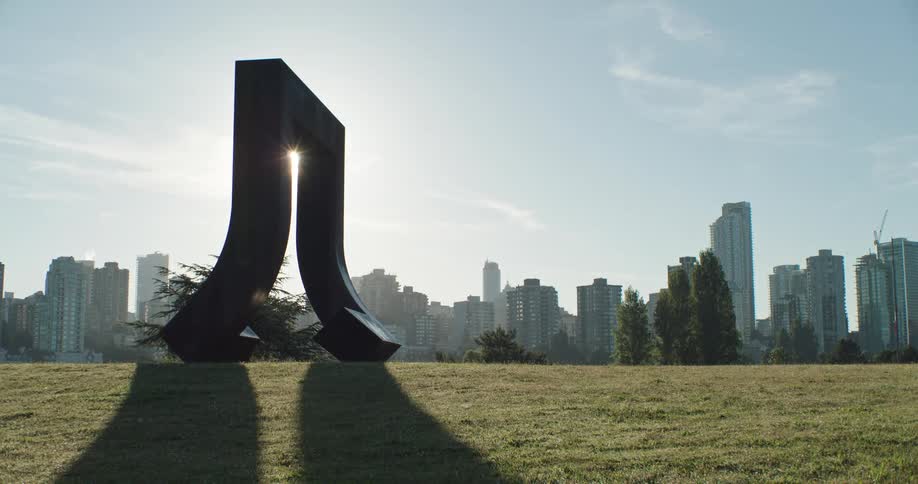 A large sculpture in a park in Vancouver city on a sunny morning