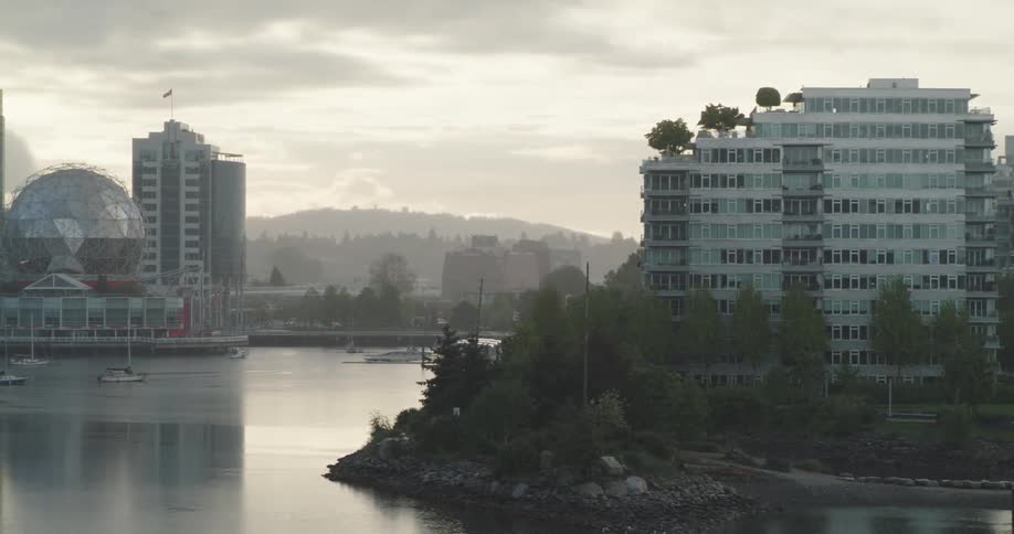 Boats sail in an ocean inlet lied with tall condos