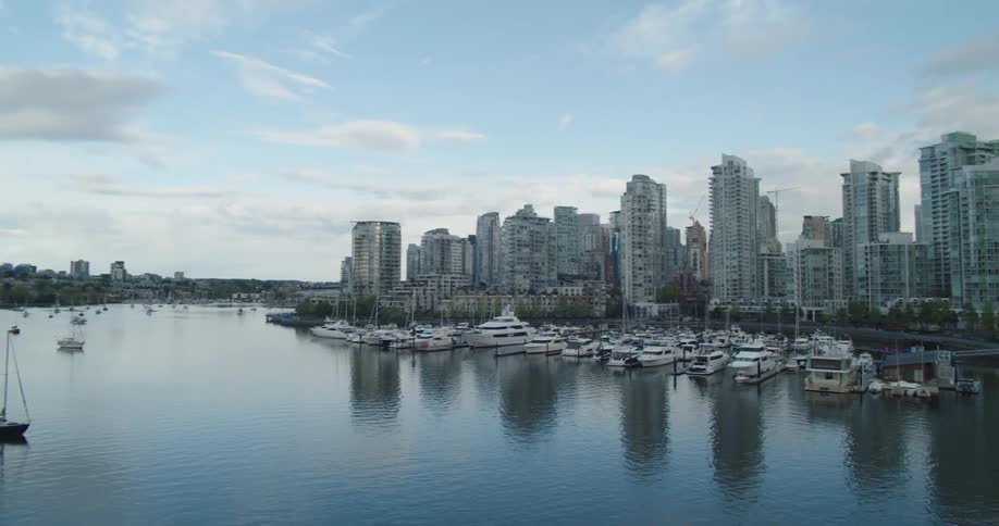 Landscape view of boats on the water in front of a Vancouver skyline