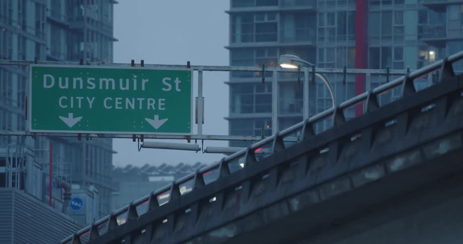 The lights of vehicles can be seen atop a Vancouver overpass as they drive towards downtown