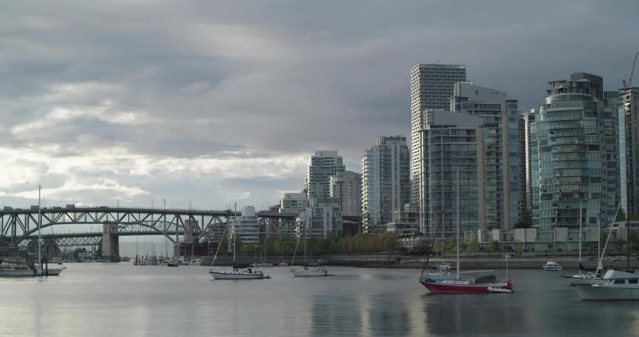 Time lapse of multiple boats sitting in Vancouver's False Creek as the sun emerges