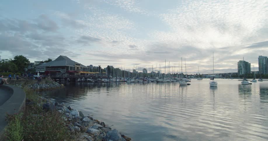 Boats docked in the marina in Vancouver's False Creek by the seawall  at sunset