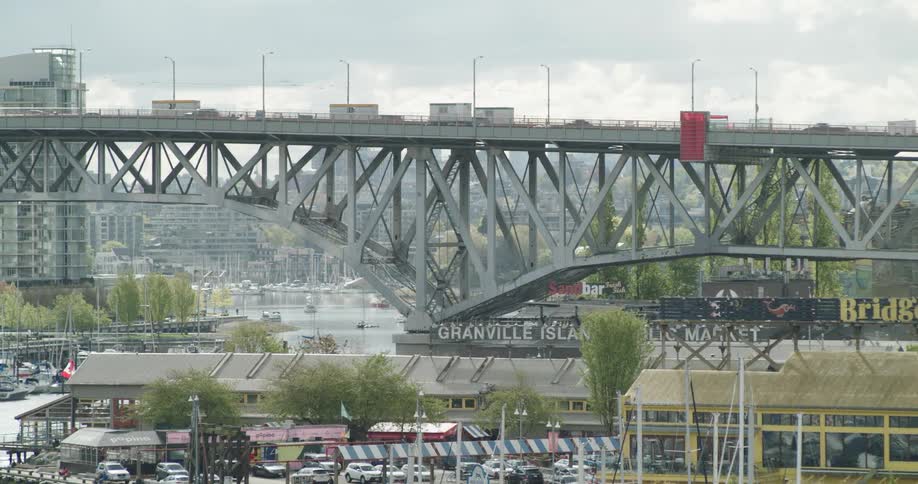 An elevated view of Vancouver's Granville Island with cars and clouds in the background