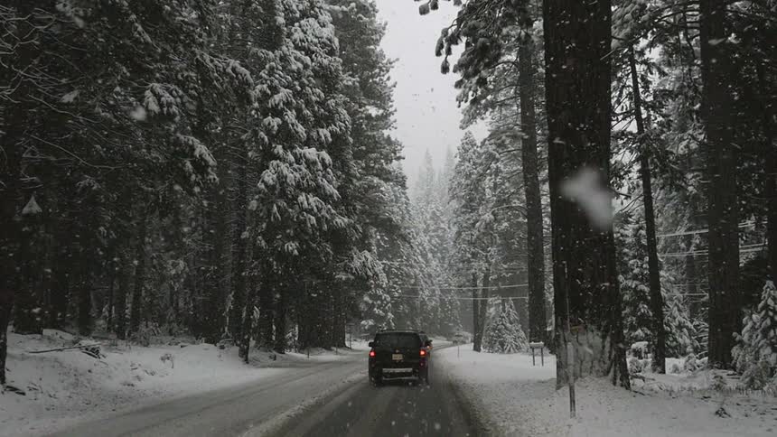Driving behind another vehicle on a snow covered mountain road