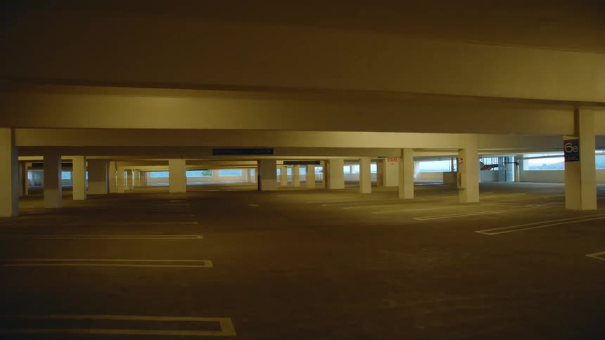 A floor of a parking garage during the day