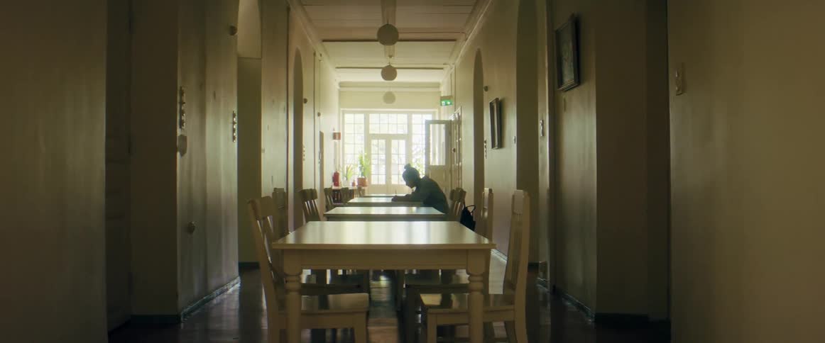 A woman sitting at a table writing