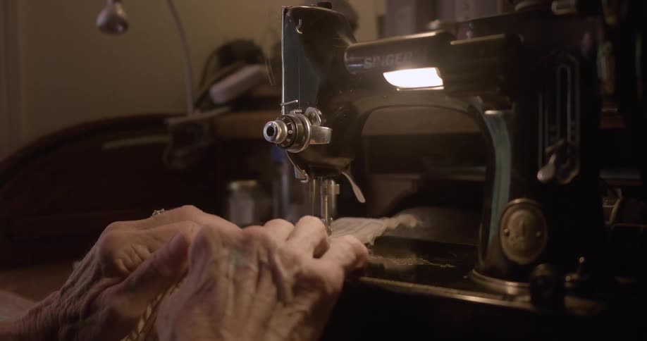 Elderly person sewing using their sewing machine