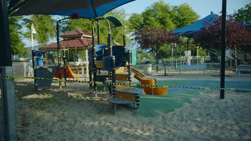 Yellow caution tape marks limited access to a color playground park