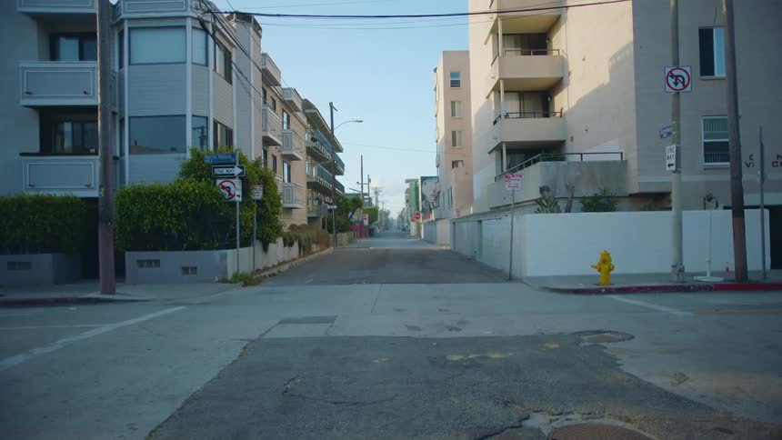An empty street near a city is displayed