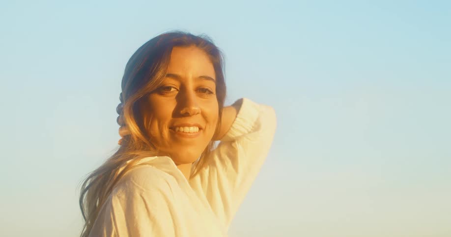 A woman standing looking into the camera