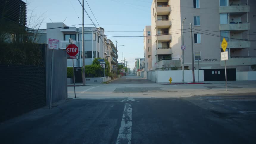 An empty road in a downtown city is displayed