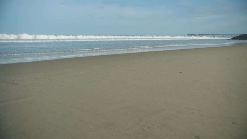 A view of the ocean from a sandy beach
