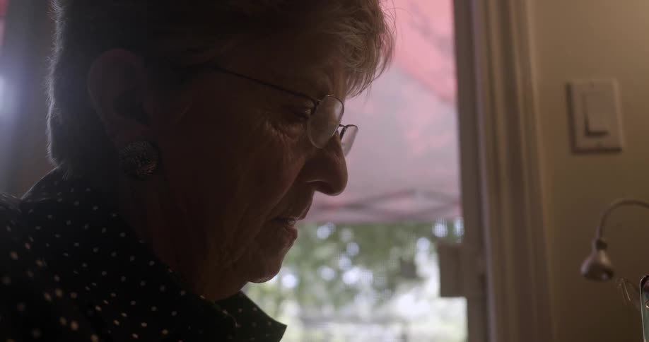 An elderly woman concentrating