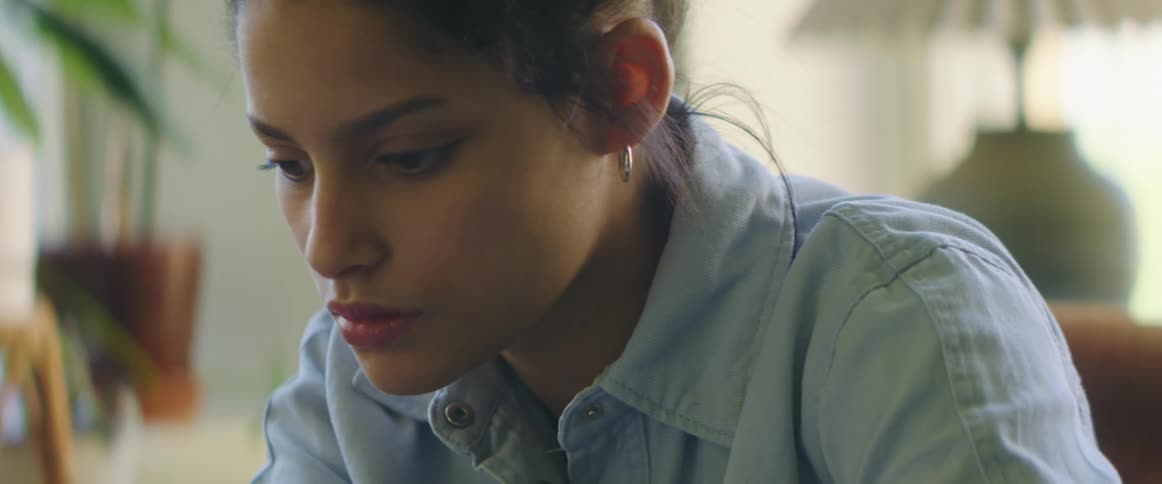 A woman focusing and reading things while writing