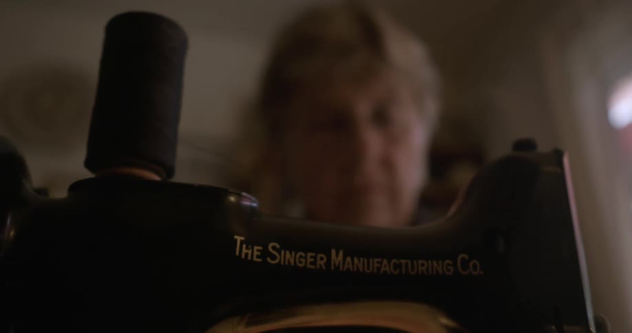 Elderly woman using her sewing machine