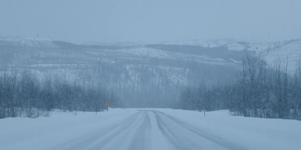 A wide shot of a road in winter