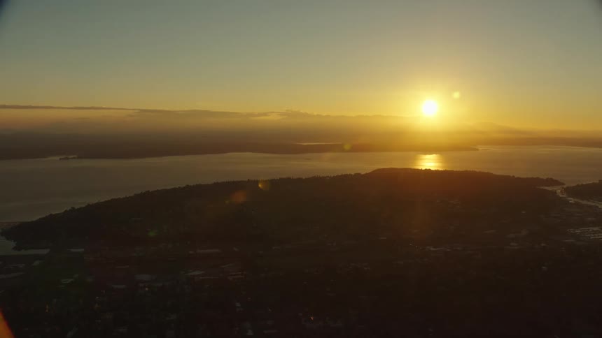The sun rises over a quiet neighborhood along the coast