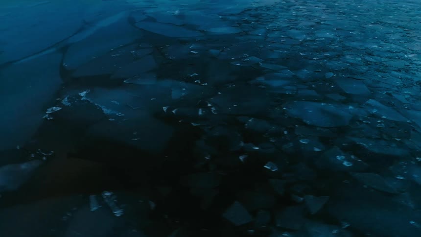 Cracks form throughout a thick layer of ice on a lake