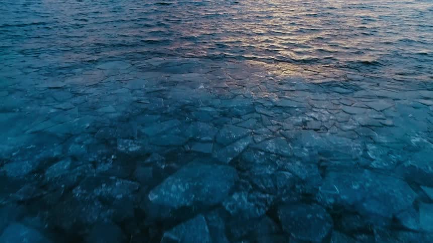 Rocks sit under the ocean water