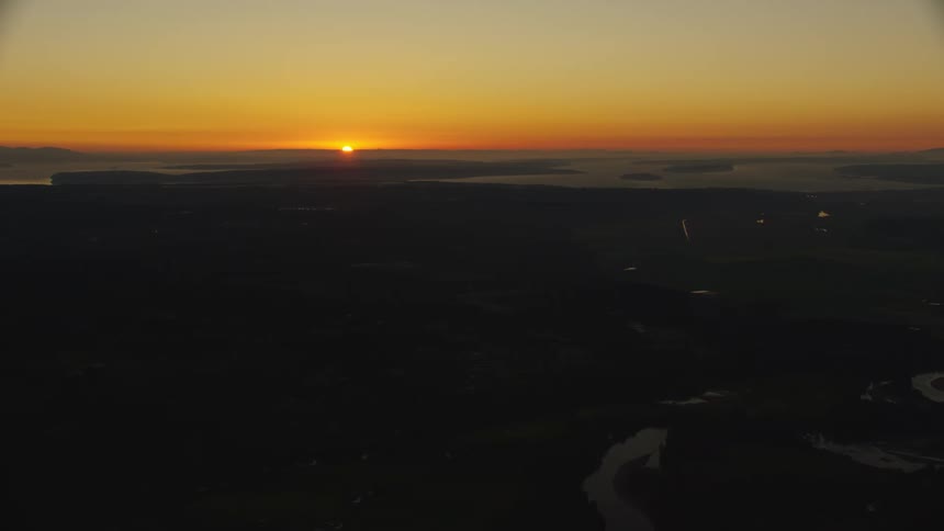 A landscape with a river with a sunset the sky and clouds in the background