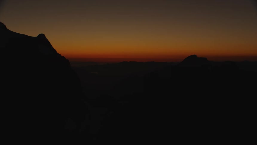 An aerial view of mountains at sunset