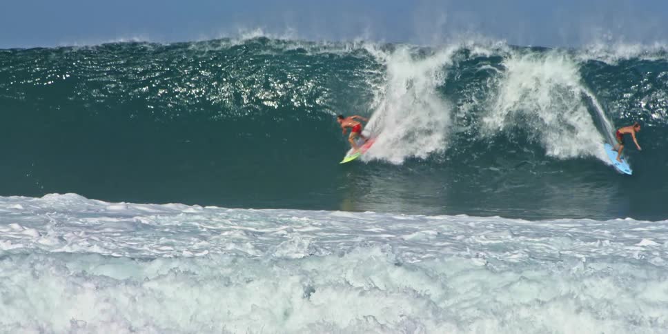 Large wave giving a ride to many surfers