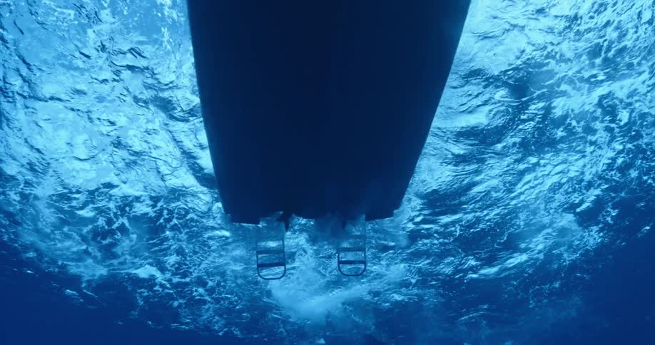 Underwater view of a boat passing overhead