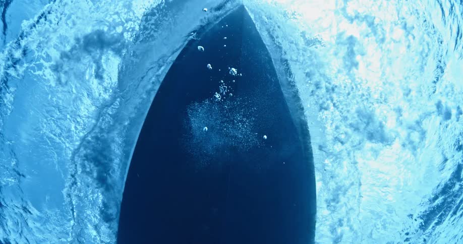 Underwater view of a boat traveling over the water