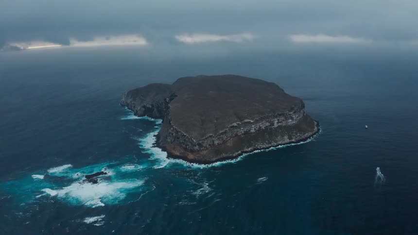 An islet in the ocean on a cloudy day