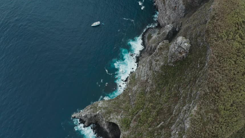 A boat is sailing from the island