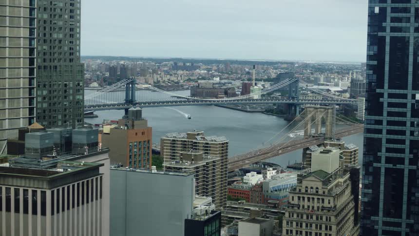 A time lapse of a bridges and boats in New York City